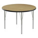 A round Correll activity table with metal legs and a black top.