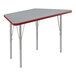 A grey high-pressure laminate trapezoid table with red trim.
