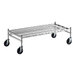 A Regency stainless steel wire dunnage rack with black wheels.