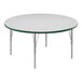 A Correll round white activity table with silver legs and green T-mold.