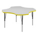 A white Correll activity table with a yellow clover-shaped top.