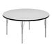 A round white table with black edges and metal legs.