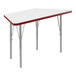 A white trapezoid-shaped table top with red edges on a table with metal legs.