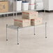 A group of boxes on a Regency stainless steel wire shelf.