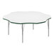 A white table with a metal frame and green edge.