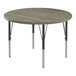 A Correll round activity table with black metal legs and a gray driftwood top with black edging.