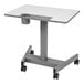 A light gray Luxor pneumatic adjustable-height student desk with pencil tray, bottle holder, and bag hook.