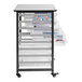 A white Luxor storage unit with a shelf and 8 small clear plastic bins.