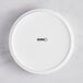 An Acopa Lore bright white porcelain deep plate with a raised rim and black text.