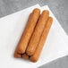 Several Tofurky vegan hot dogs on a white paper towel.