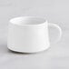 A bright white Acopa Lore espresso cup with a handle.