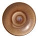 A brown porcelain plate with a blue circle in the center.