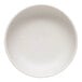 A white round Libbey Driftstone porcelain low bowl with a speckled surface.