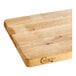 A wooden Choice cutting board on a counter.