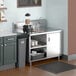 A Regency stainless steel beverage table with a sink on a kitchen counter.