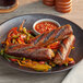 A plate of Impossible Foods Spicy Sausage with peppers and onions.