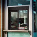 A bronze Ready Access drive-thru window with a sign on the window that says open.