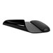 A close-up of a black StarTech mouse pad with a curved edge and a black computer mouse on it.