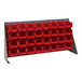 A Quantum gray steel bench rack with red bins attached.
