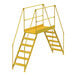 A yellow metal Vestil crossover ladder with handrails.