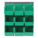 A Quantum gray steel louvered panel with green plastic bins on it.