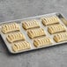 A baking tray with several Bridor Ready-to-Bake Strawberry Cheesecake Danish pastries.