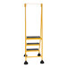 A yellow Vestil commercial rolling step ladder with black serrated steps.