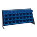 A Quantum gray steel bench rack with blue bins on a white background.