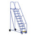 A blue Vestil steel rolling warehouse ladder with wheels.