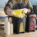 A man using a ServSense plastic pump to dispense condiments into a white cup.