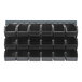 A Quantum louvered panel with black bins hanging on it.