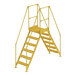 A yellow Vestil steel crossover ladder with handrails and metal steps.