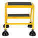 A yellow Vestil commercial rolling step ladder with black rubber legs.