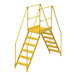 A yellow Vestil steel crossover ladder with 6 steps and metal bars.