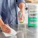 A person cleaning a counter in a professional kitchen with a Lavex paper towel.