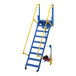 A blue and yellow Vestil steel electric folding mezzanine ladder with a yellow handle.