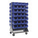A Quantum mobile steel louvered rack with blue bins on it.