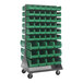 A gray Quantum mobile louvered rack with green bins on it.