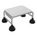 A white Vestil commercial rolling step ladder with black rubber feet.