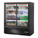 A True black refrigerated glass door merchandiser with drinks and beverages inside.