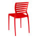 A red resin side chair with slats.