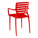 A red plastic Lancaster Table & Seating Sol Buoy arm chair.