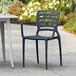 A blue resin arm chair with a slatted backrest, designed for outdoor use.