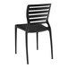 A black stone resin side chair with a slatted back.