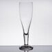 A Stolzle stemmed pilsner glass on a table with a white background.