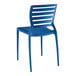 A Lancaster Table & Seating Sol Sea Blue resin side chair with a slat back.