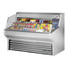 A True stainless steel horizontal refrigerated air curtain merchandiser displaying food and drinks.