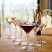 A group of Stolzle Exquisit Bordeaux wine glasses on a table.