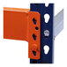 A close-up of an orange Interlake Mecalux pallet rack beam with blue and orange bolts.