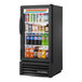 A black True Refrigerated Glass Door Merchandiser full of drinks.